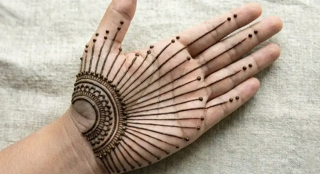 19+ Best Easy Front Hand Mehndi Designs (Step-by-Step) 12 Dynamic sunburst henna design with lines radiating from the wrist to the fingers on the front hand.