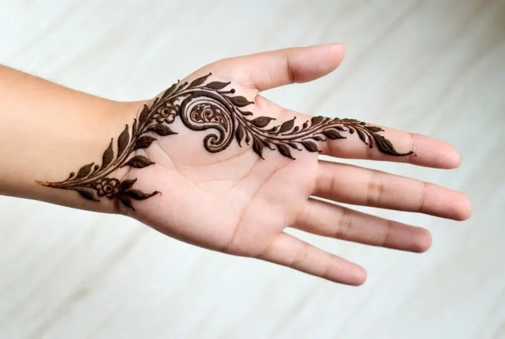 19+ Best Easy Front Hand Mehndi Designs (Step-by-Step) 3 Easy Arabic style floral vine henna pattern flowing diagonally across the front hand.