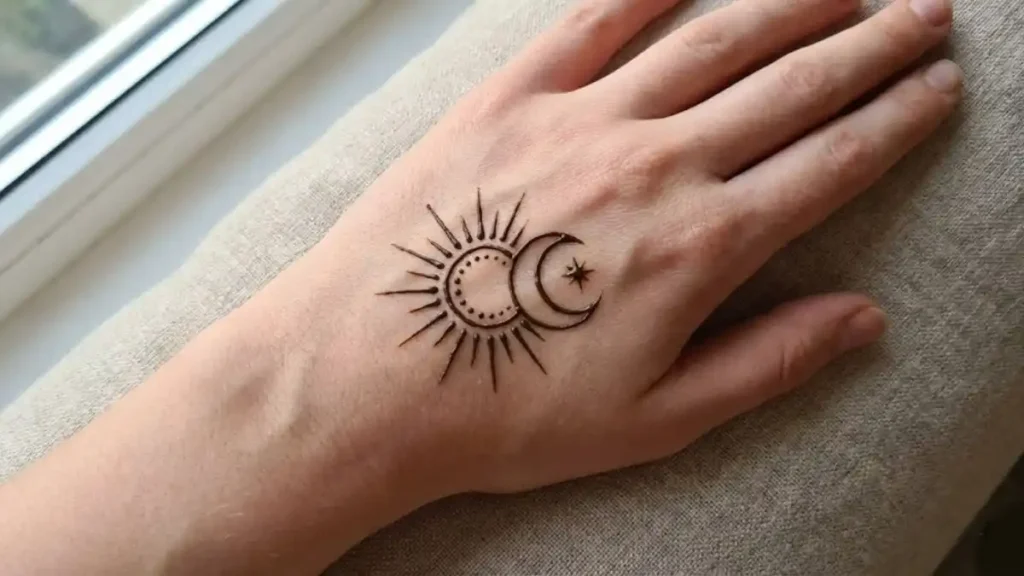 20 Stylish and Simple Back Hand Mehndi Designs 15 Minimalist sun and moon celestial henna design on the back hand.